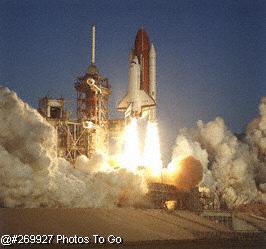 Space shuttle lifting off launch pad